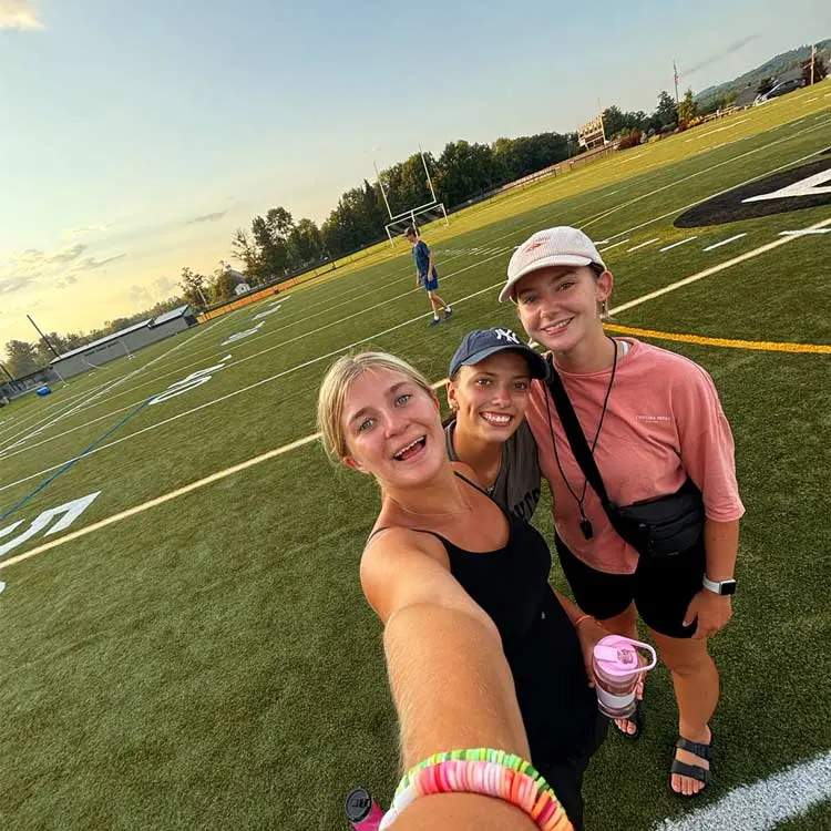 Girls standing on an American football field