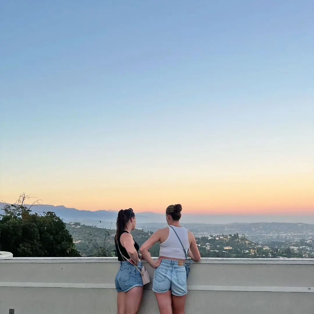 2 girls overlook Los Angeles on fine evening