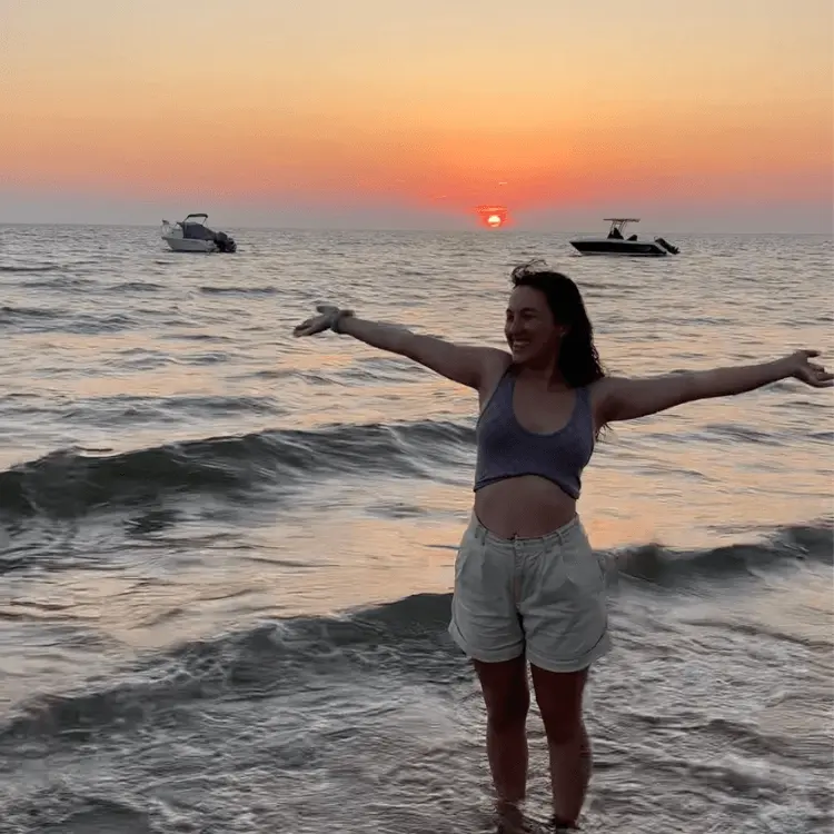 Young girl in sea at sunset in Cape Cod USA